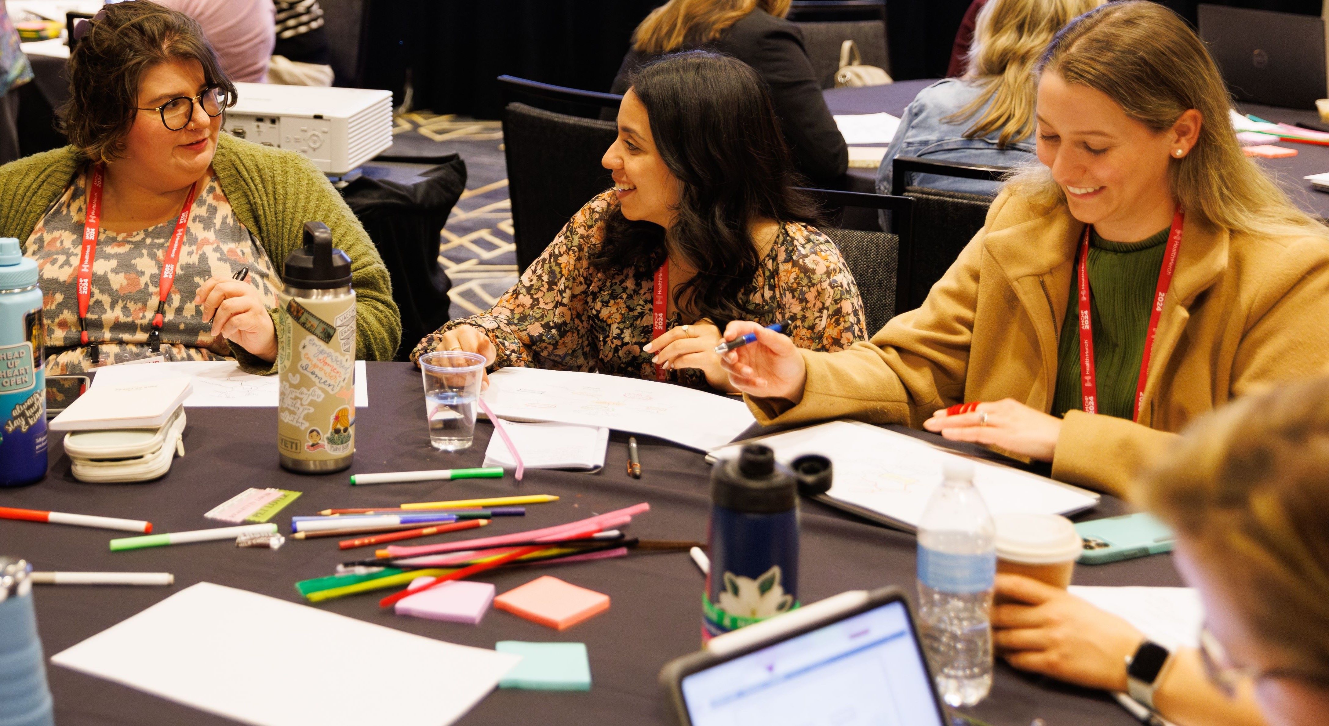 Attendees at a table during an education session