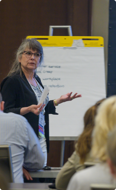 An industry professional facilitates a discussion during a conference session.